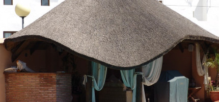 Tropical thatched roof in cylindrical and turned wood